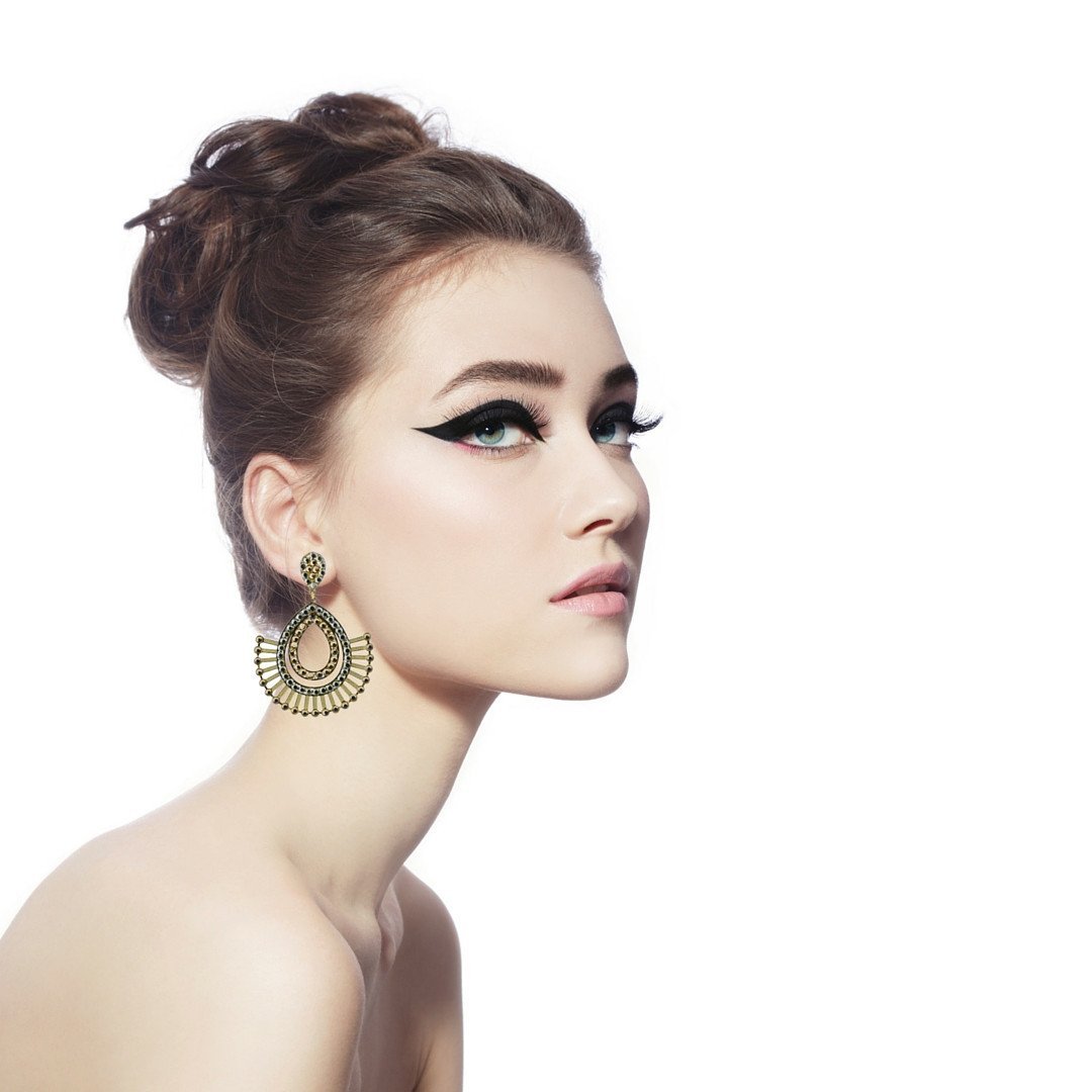 Beautiful profile of model wearing large geometric shaped crystal earrings. Link directs user to the evening jewelry menu